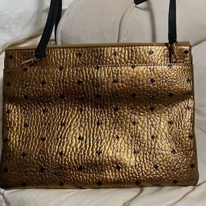 Bronze with black trim MCM crossbody bag / clutch bag.